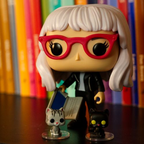 Me as a Funko Pop doll holding a laptop and accompanied by 2 Funko Pop cats that resemble my cats, Anakin and Kubrick